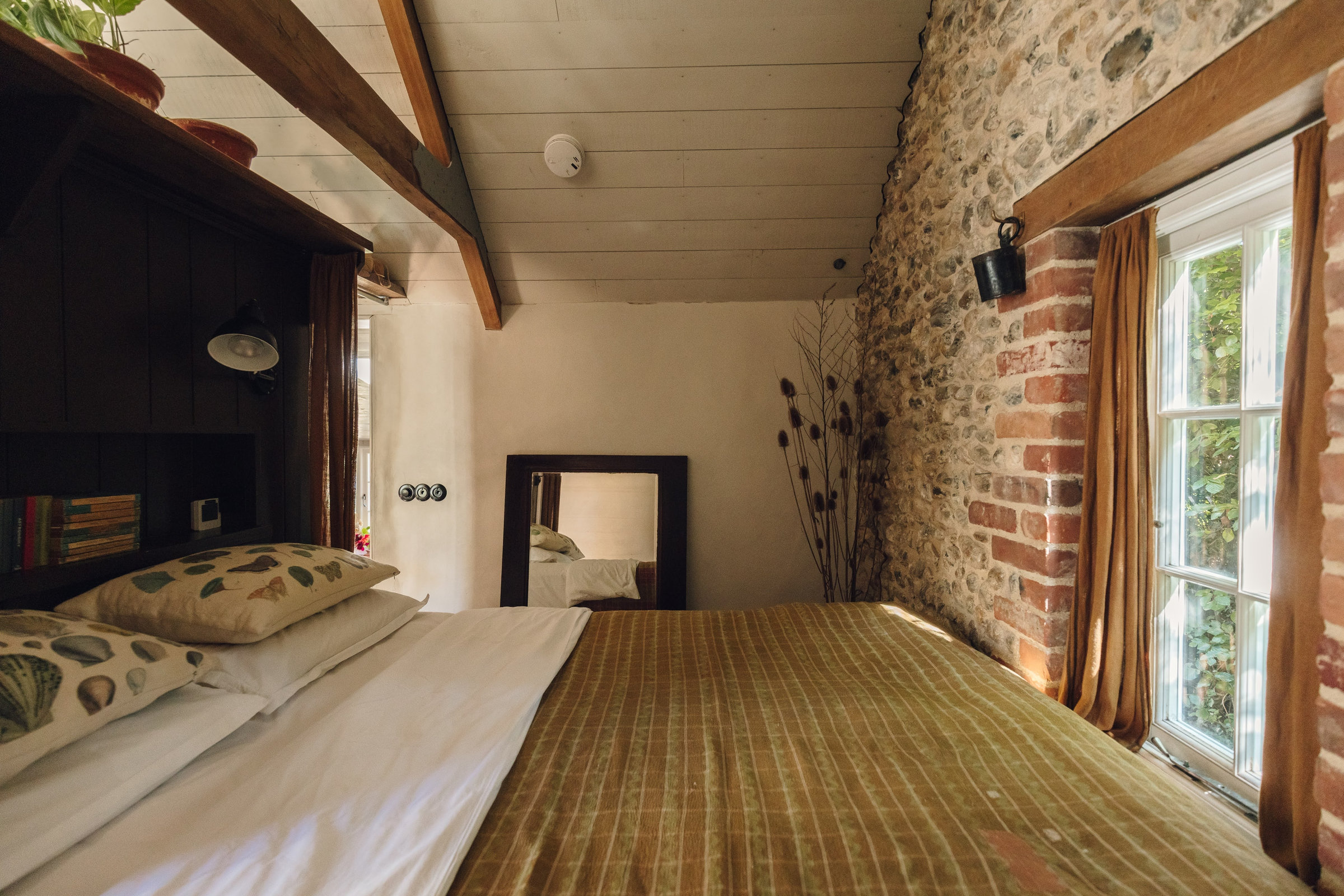 The bedroom, with the bed beneath the eaves
