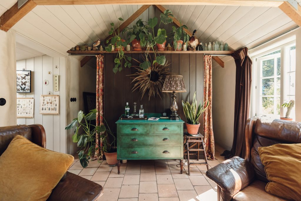 The sitting room with its vaulted ceiling, green chest and leather sofa