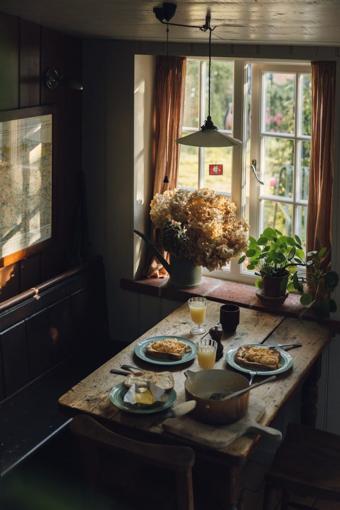 Breakfast laid on the table by the cottage window